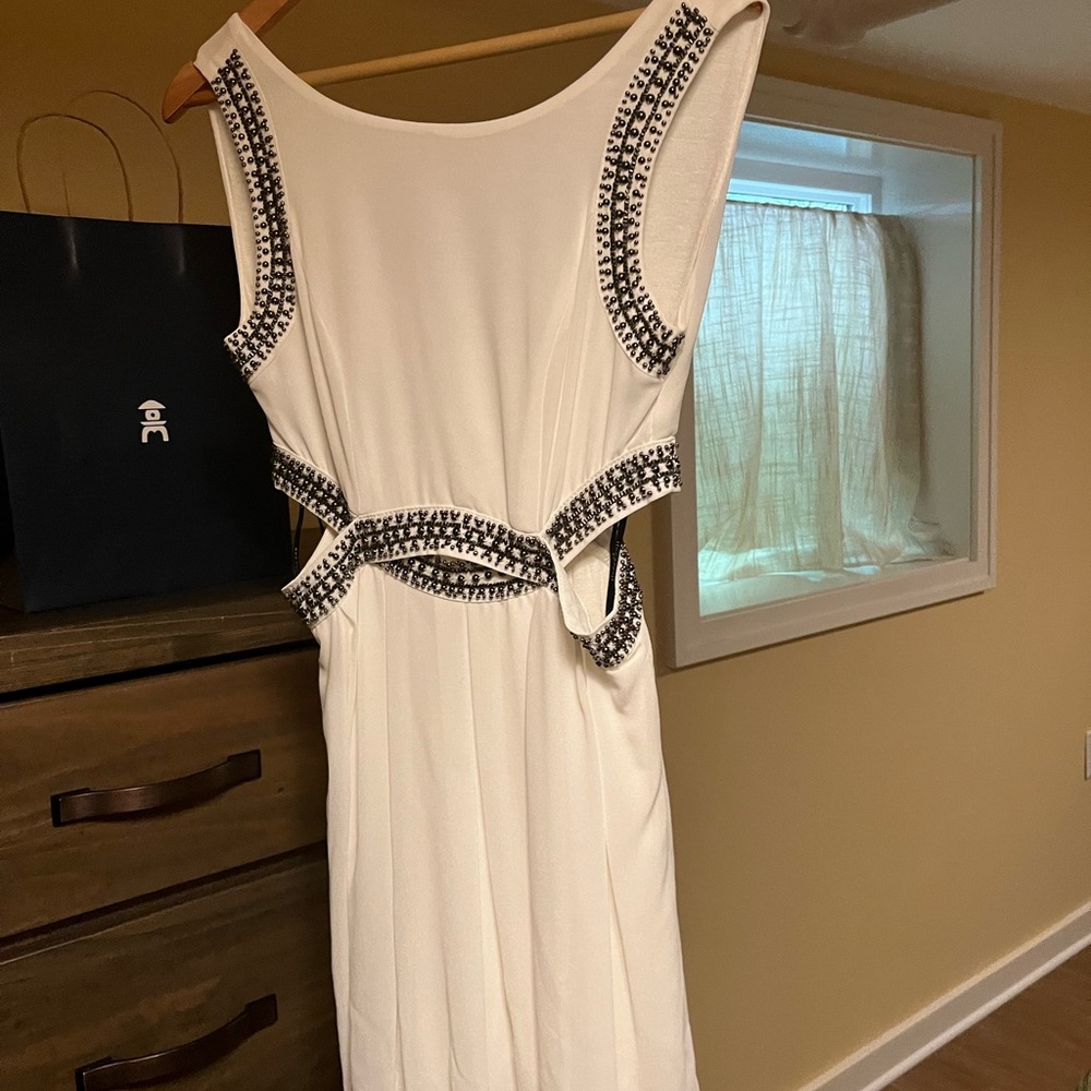 White dress with metal detail and cut outs
